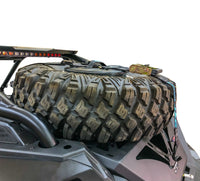 Spare tire storage bag sitting inside inverted off road wheel